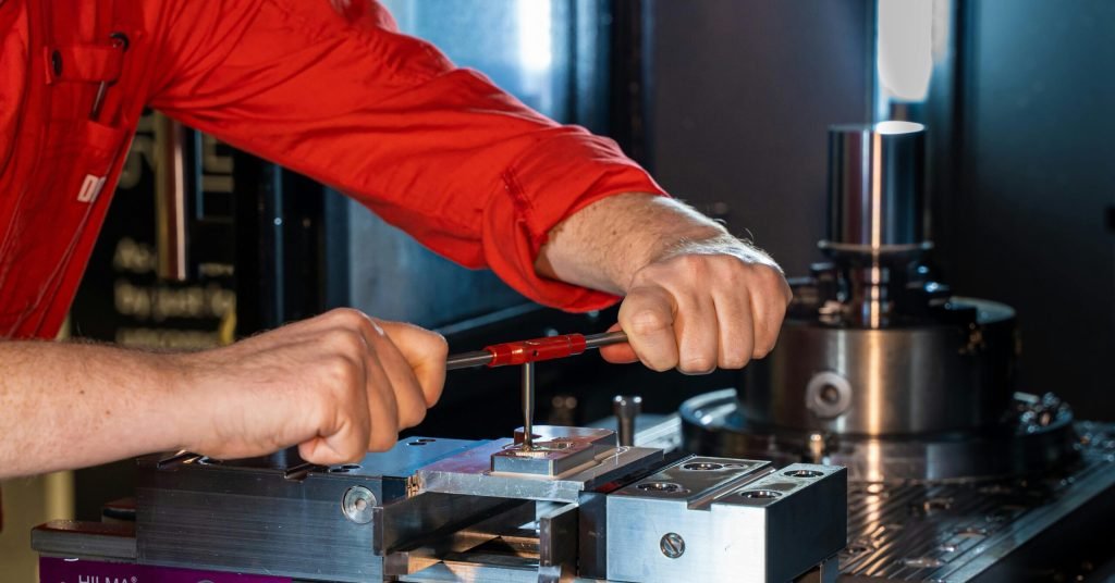 Person in Red Long Sleeve Shirt Holding Red and Black Hand Tool